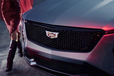Close-up of a Woman Walking Past the 2025 Cadillac XT4 Grille 